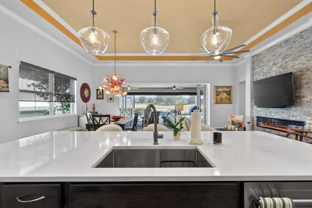 a living room with furniture a flat screen tv and a floor to ceiling window