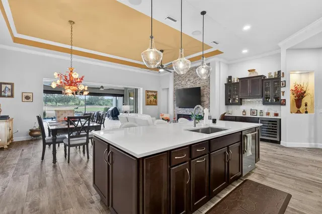 a living room with furniture a floor to ceiling window and a flat screen tv