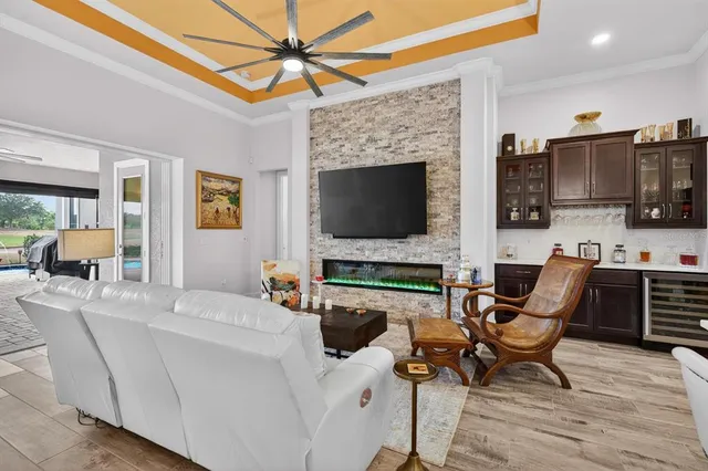 a living room with patio furniture and a flat screen tv
