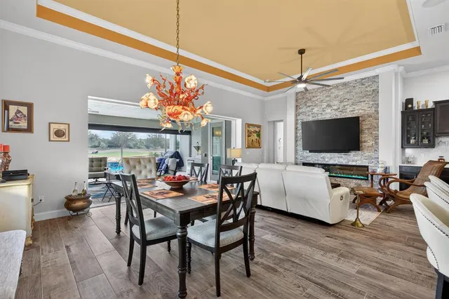 a view of a patio with a table chairs and a backyard