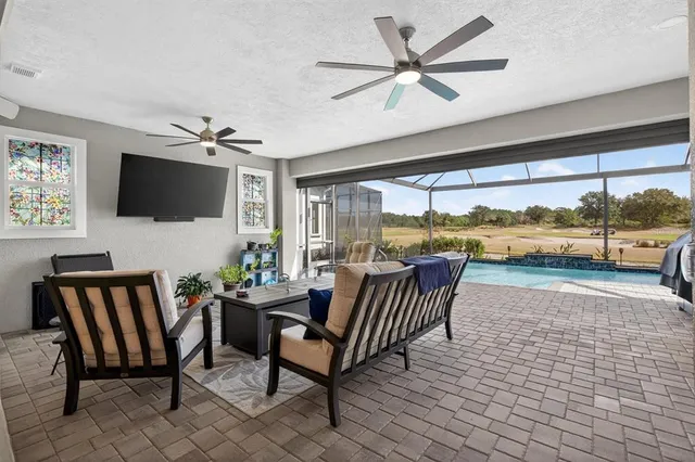 a bedroom with a bed window and a flat screen tv