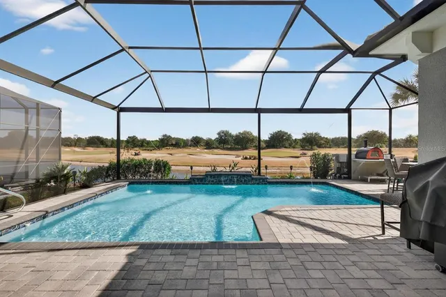 a front view of a house with a yard and potted plants