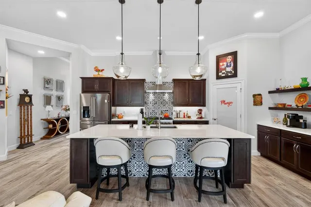 a kitchen with stainless steel appliances a sink stove and refrigerator