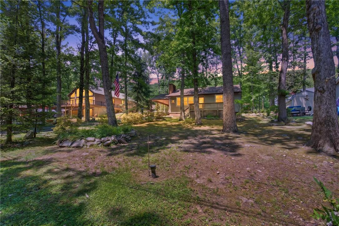 18 White Oak Road Nesquehoning, PA 18240 - Photo 40 of 52 Two wooded homes nestled among mature trees offer tranquil living spaces with illuminated exteriors.