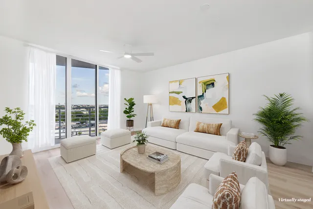 a living room with furniture and a potted plant