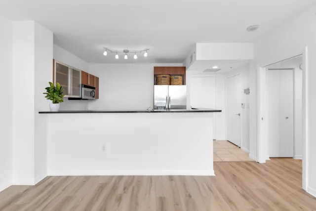 a view of a kitchen cabinets and wooden floor