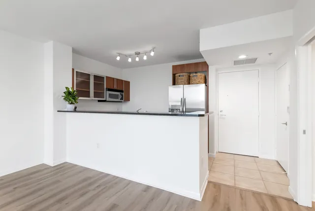 a view of a kitchen cabinets and wooden floor