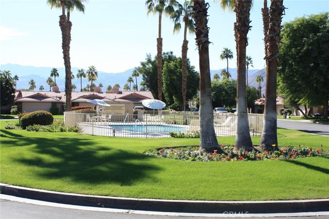 a view of a bench in front of a garden