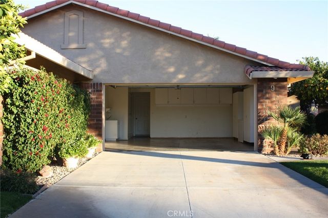 a backyard of a house with plants and trees