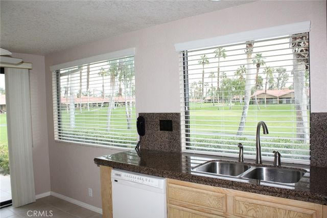a kitchen with a sink and large window