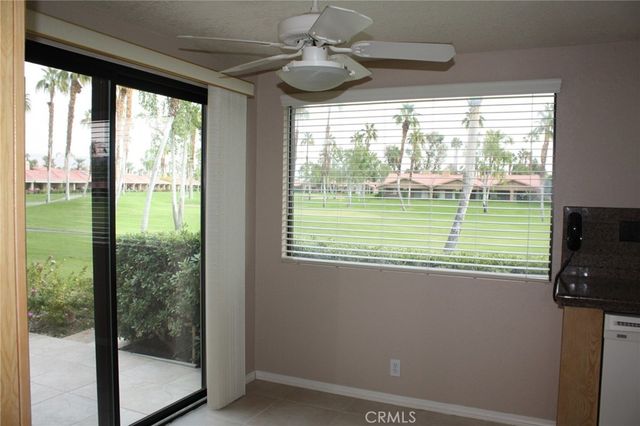 a room with a large window and a bed