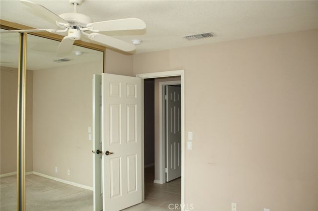 a view of a hallway with a chandelier fan