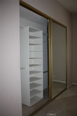 a view of walk in closet with empty racks