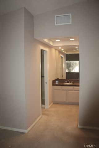 a large bathroom with a large mirror vanity and sink