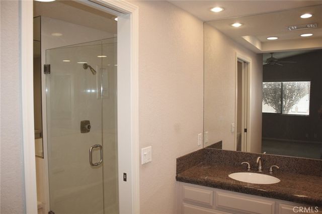 a bathroom with a sink shower and a mirror