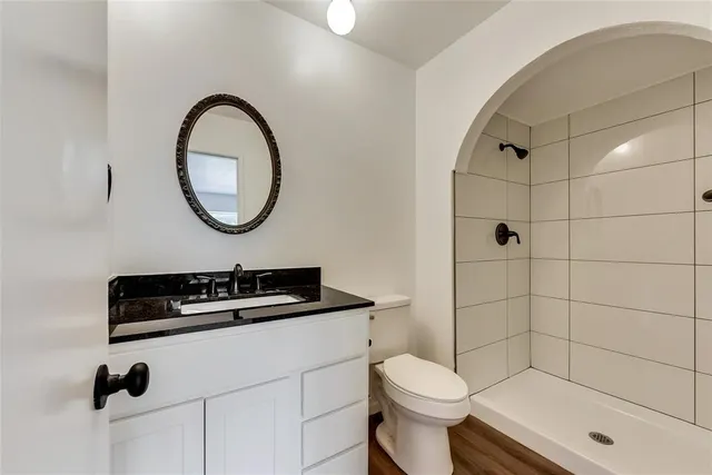 a bathroom with a sink a toilet and a shower