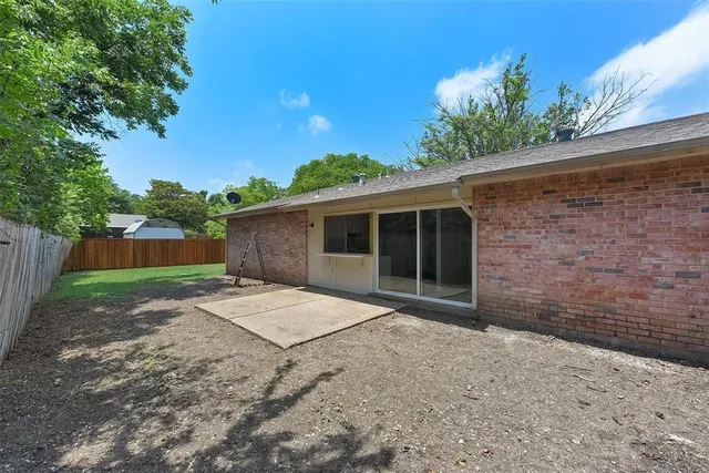 a view of backyard of house with green space