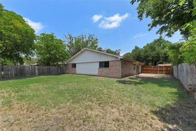 a backyard of a house with lots of green space