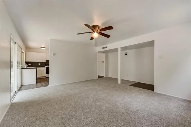a view of a kitchen with a sink and a refrigerator
