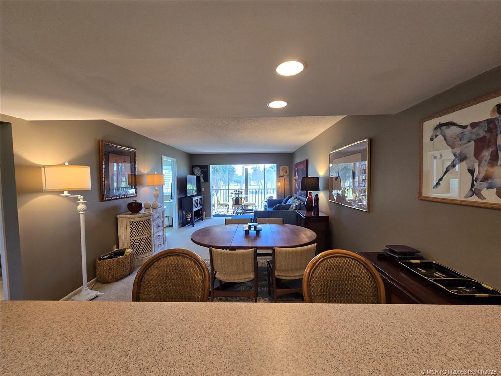 5564 Northeast Gulfstream Way Stuart, FL 34996 - Photo 11 of 41 a living room with furniture a window and kitchen view