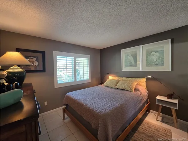 a bedroom with two beds and a window