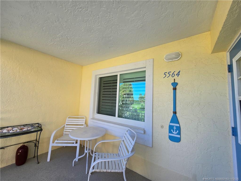 5564 Northeast Gulfstream Way Stuart, FL 34996 - Photo 2 of 41 a living room with a table chair and a window