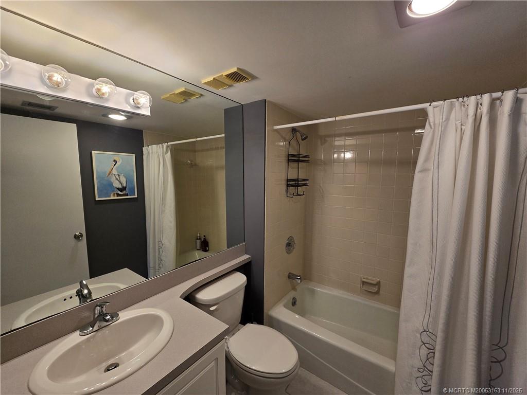 5564 Northeast Gulfstream Way Stuart, FL 34996 - Photo 24 of 41 a bathroom with a sink toilet and shower