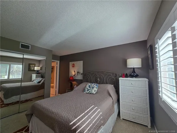 a bedroom with furniture and a flat screen tv