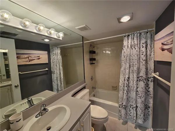 a bathroom with a sink double vanity and a mirror