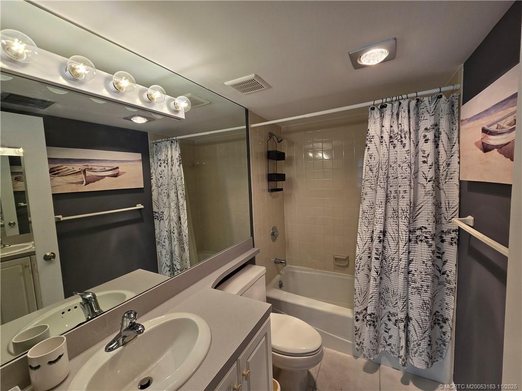 5564 Northeast Gulfstream Way Stuart, FL 34996 - Photo 29 of 41 a bathroom with a sink a toilet and shower