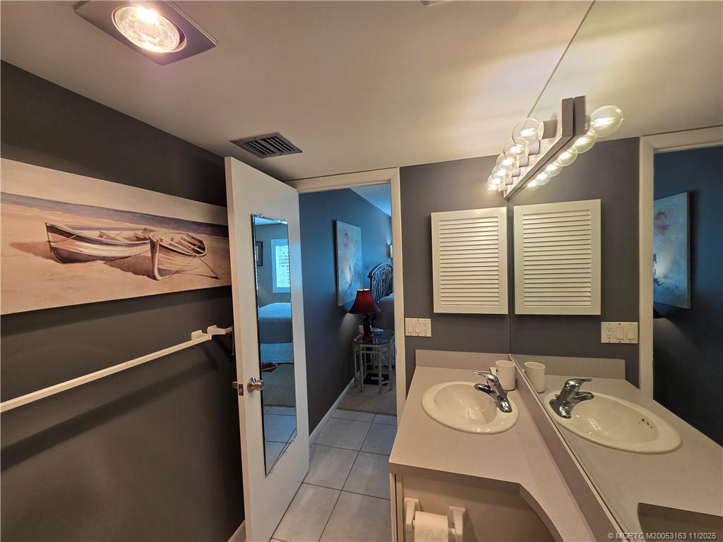 5564 Northeast Gulfstream Way Stuart, FL 34996 - Photo 30 of 41 a bathroom with a sink double vanity and a mirror