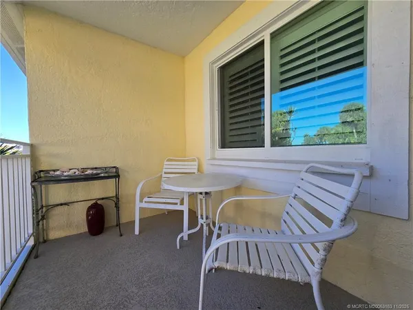 a view of a patio with a table and chairs