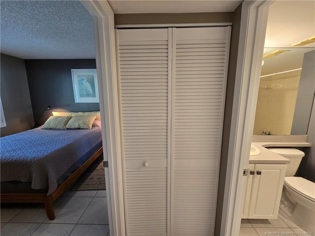 5564 Northeast Gulfstream Way Stuart, FL 34996 - Photo 31 of 41 a room with a bed and a window