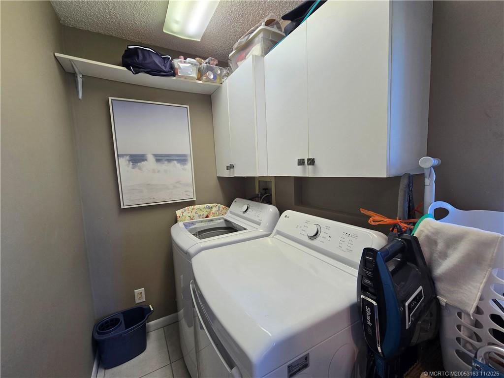 5564 Northeast Gulfstream Way Stuart, FL 34996 - Photo 32 of 41 a utility room with dryer and washer