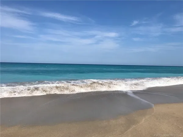 a view of an ocean beach and city