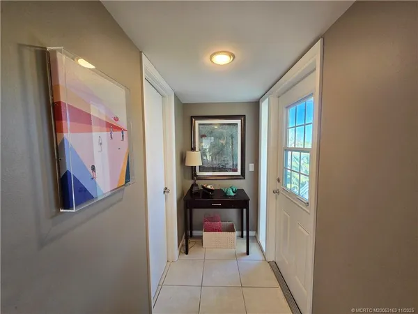 a hallway with wooden floor and furniture