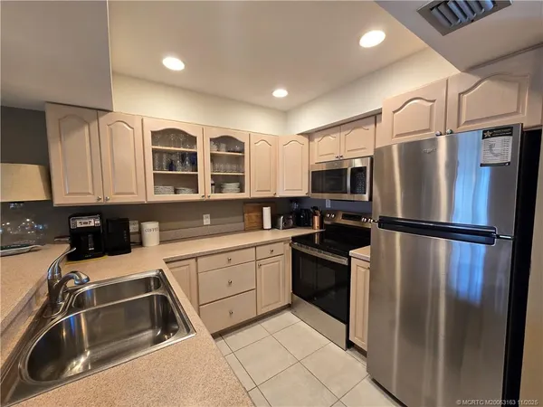 a kitchen with a refrigerator and a sink