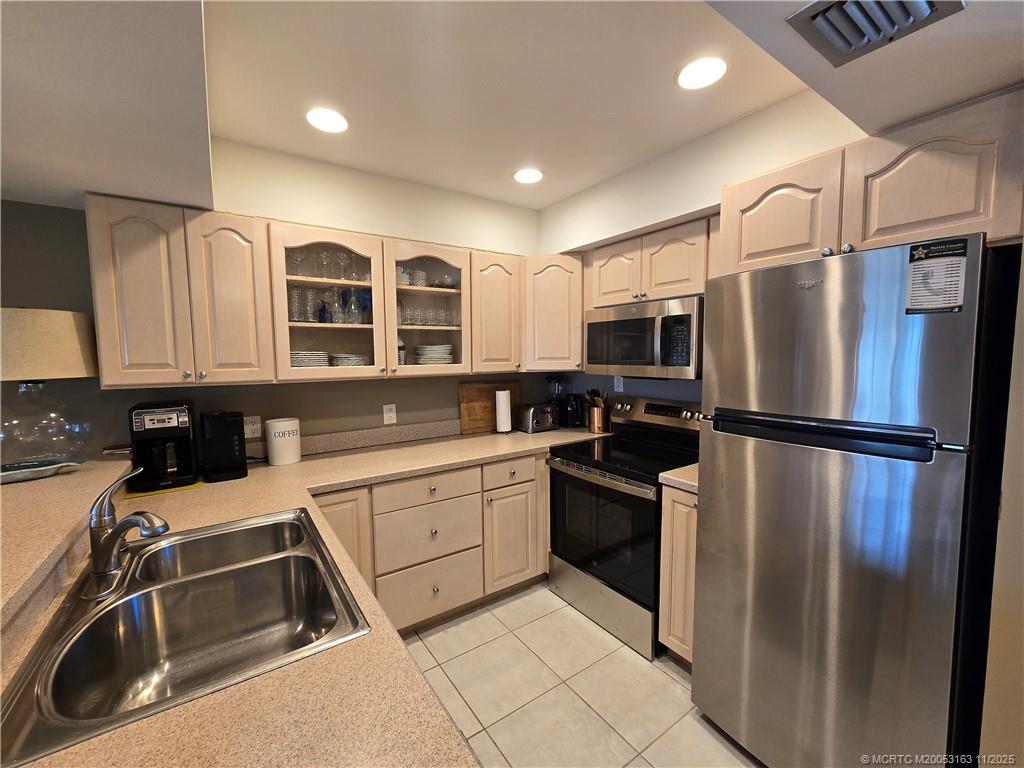 5564 Northeast Gulfstream Way Stuart, FL 34996 - Photo 9 of 41 a kitchen with stainless steel appliances granite countertop a refrigerator and a sink