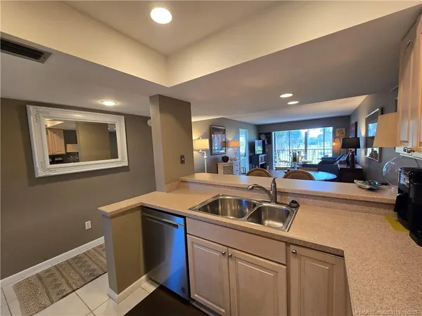 a living room with furniture a window and kitchen view