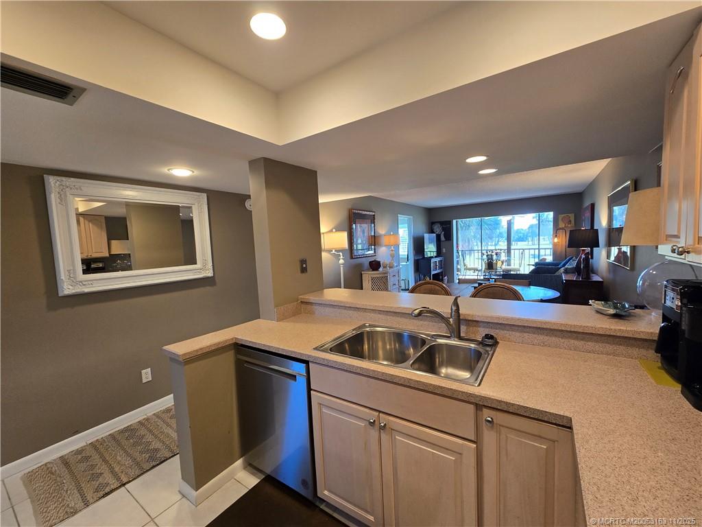 5564 Northeast Gulfstream Way Stuart, FL 34996 - Photo 10 of 41 a kitchen with a refrigerator and a sink