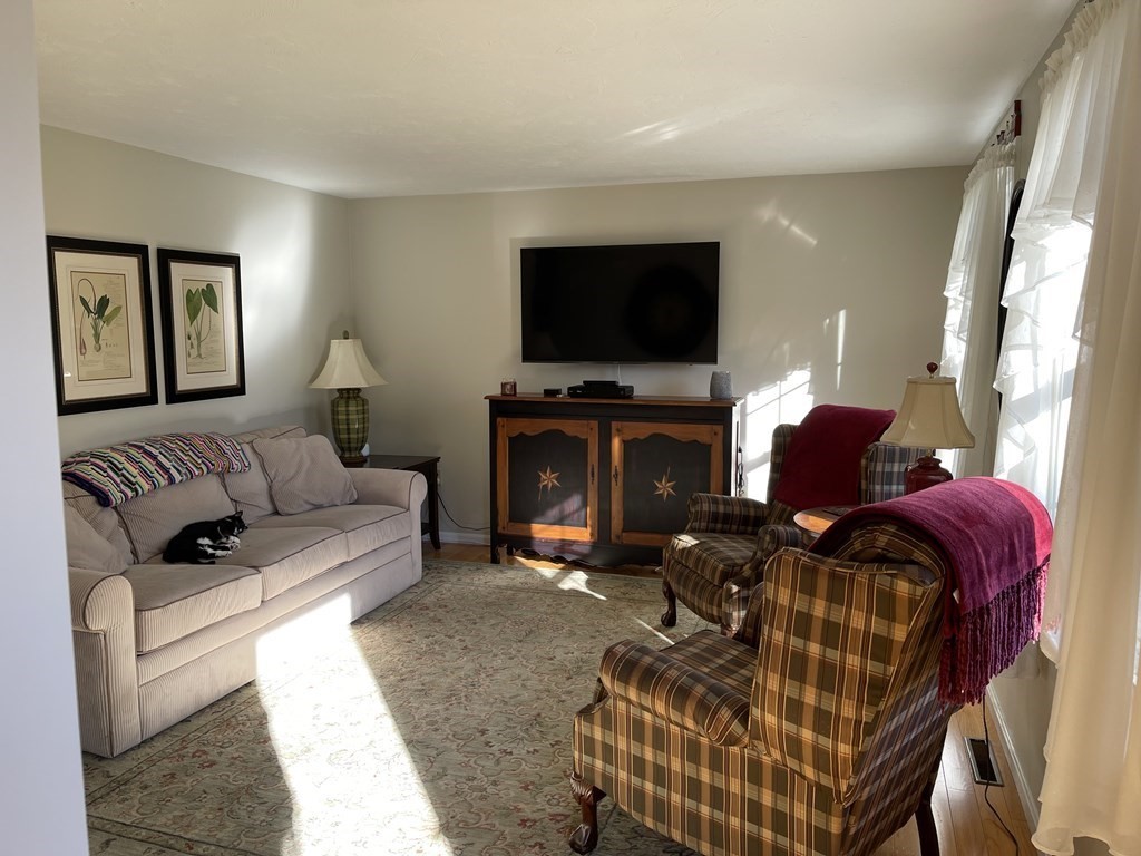 5 Collins Circle Weymouth, MA 02190 - Photo 15 of 42 a living room with furniture and a flat screen tv