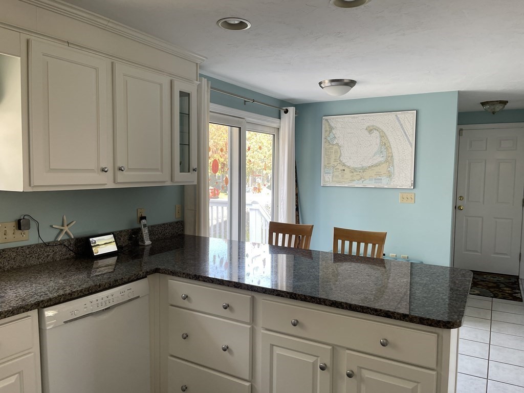 5 Collins Circle Weymouth, MA 02190 - Photo 17 of 42 a kitchen with granite countertop white cabinets and black appliances