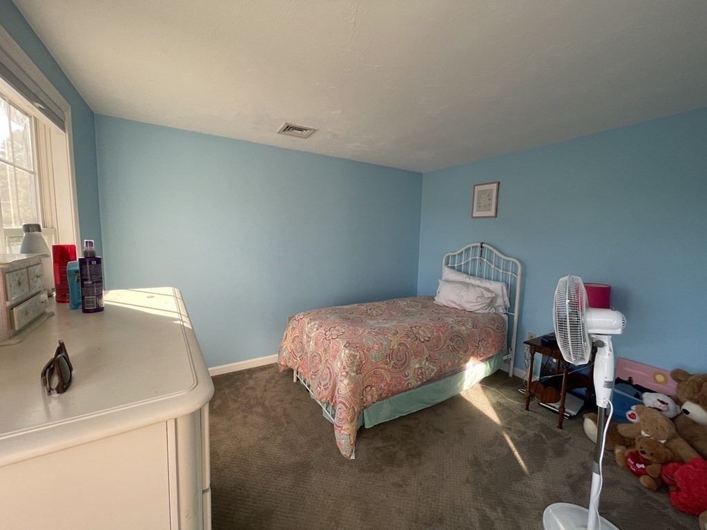 5 Collins Circle Weymouth, MA 02190 - Photo 29 of 42 a bedroom with a bed and a table in it
