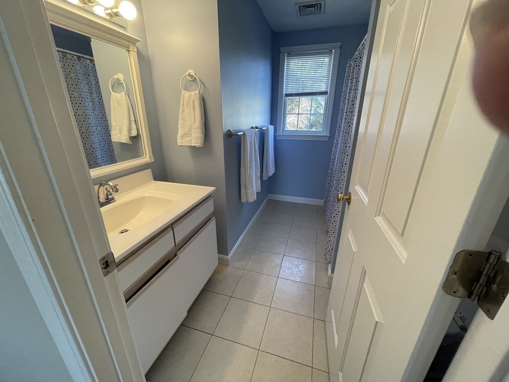 5 Collins Circle Weymouth, MA 02190 - Photo 31 of 42 a bathroom with a bathtub sink and mirror