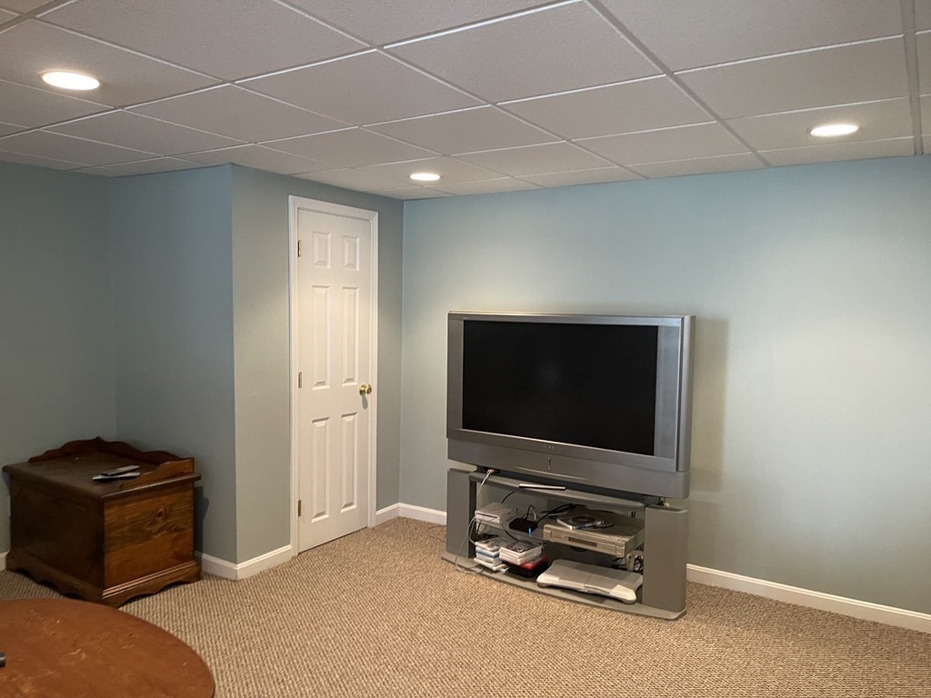5 Collins Circle Weymouth, MA 02190 - Photo 38 of 42 a living room with furniture and a flat screen tv