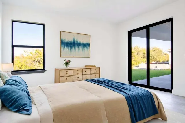 a bedroom with a bed and glass window