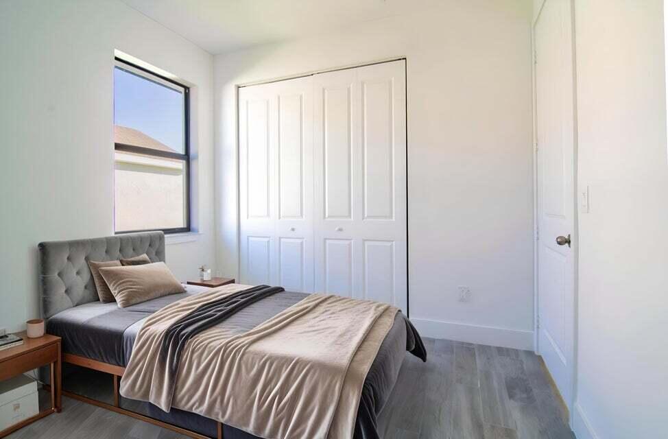 8126 Thruso Road Port Charlotte, FL 33981 - Photo 12 of 32 a bedroom with a bed and a window