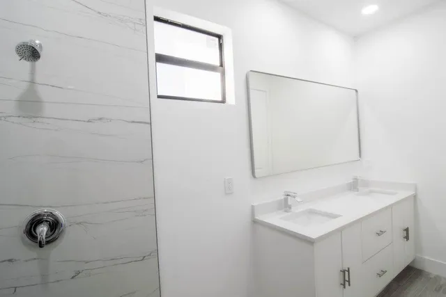a bathroom with a sink a vanity and a mirror