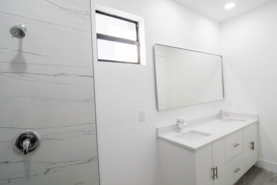 8126 Thruso Road Port Charlotte, FL 33981 - Photo 19 of 32 a bathroom with a sink a vanity and a mirror