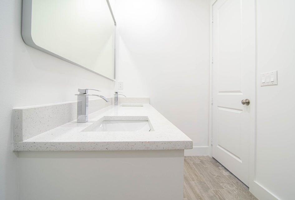 8126 Thruso Road Port Charlotte, FL 33981 - Photo 20 of 32 a bathroom with a sink and a mirror